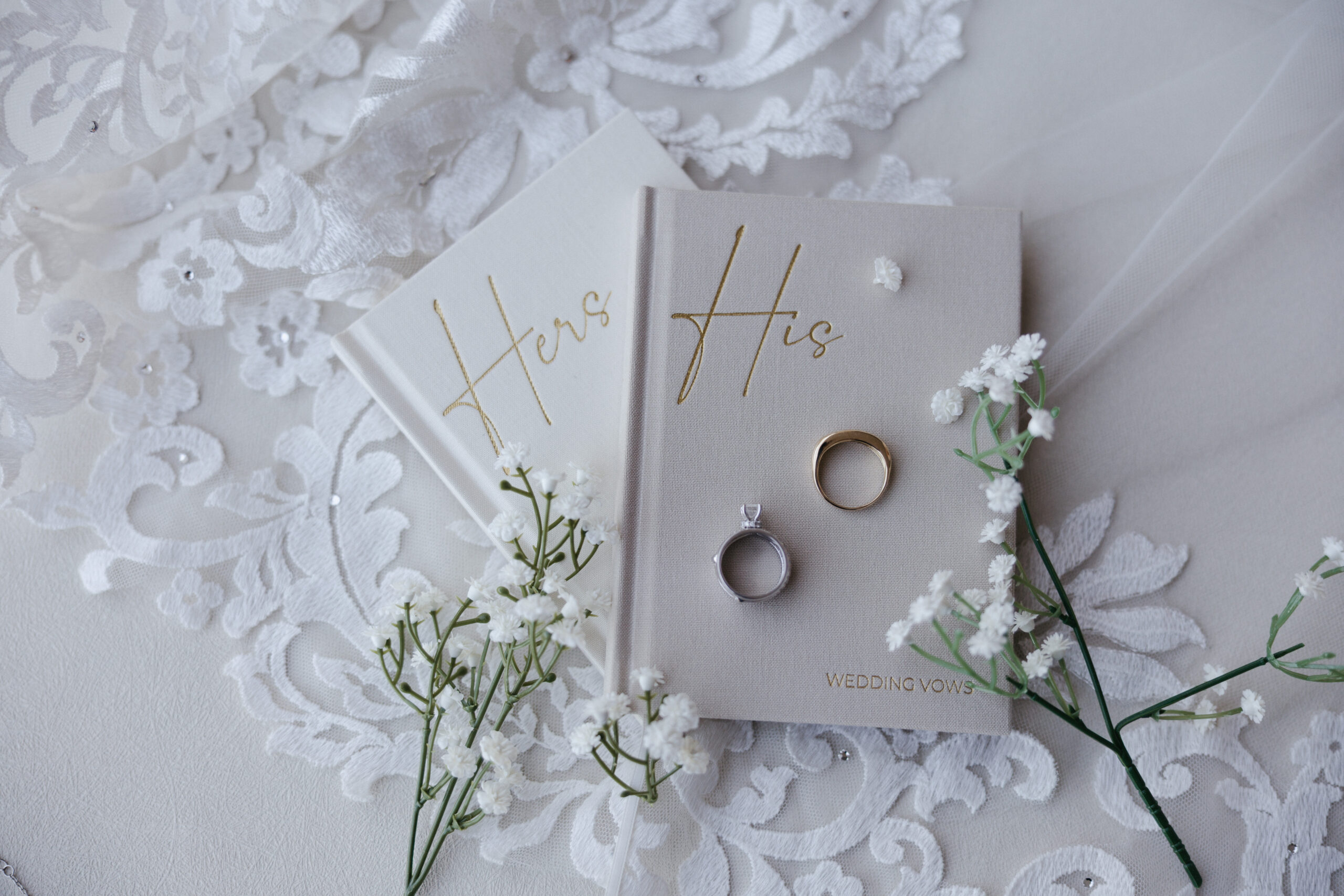 Wedding vow books and wedding rings in a flatlay wedding photo