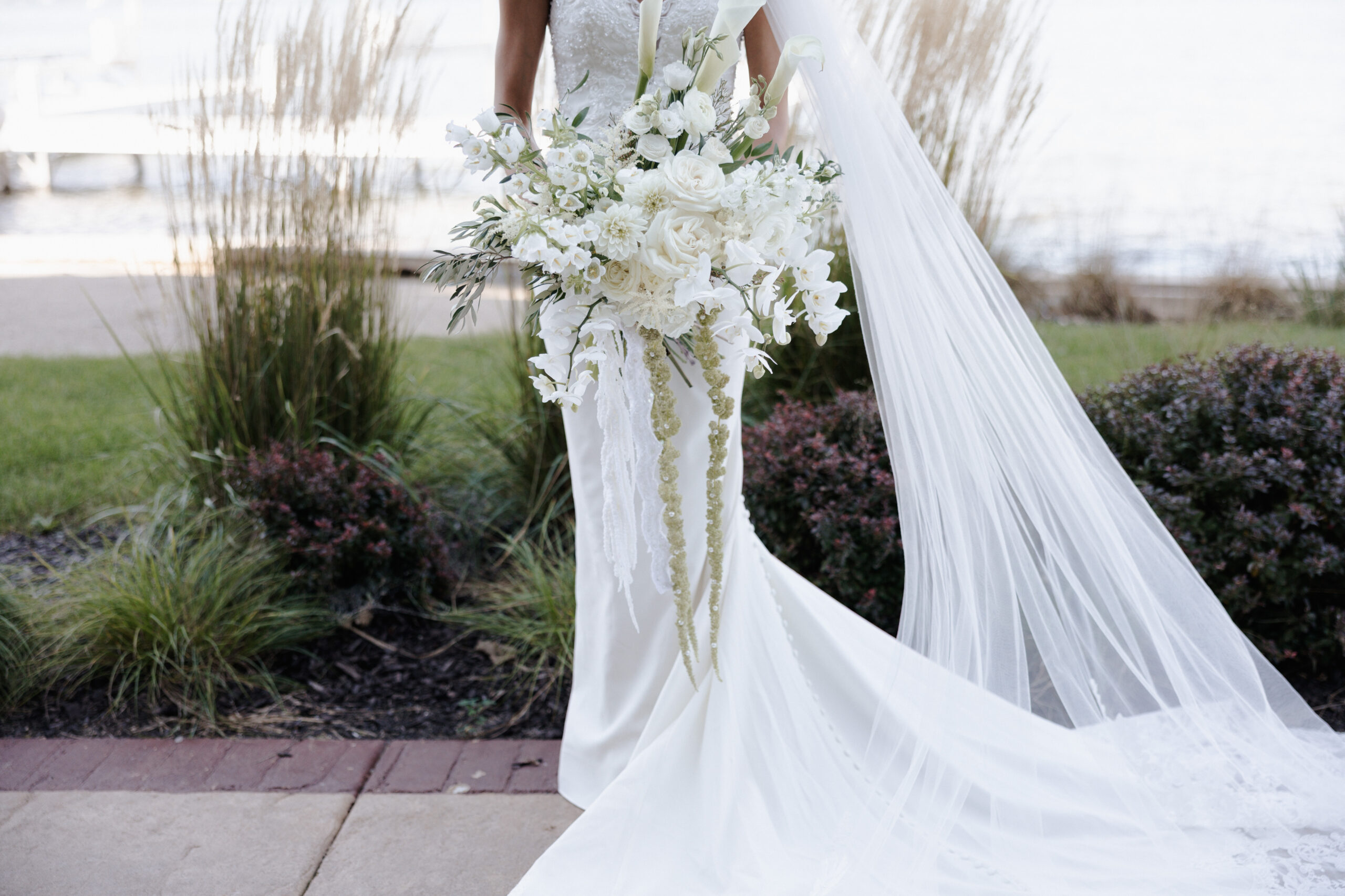 Editorial wedding photo of bride holding her white wedding bouquet