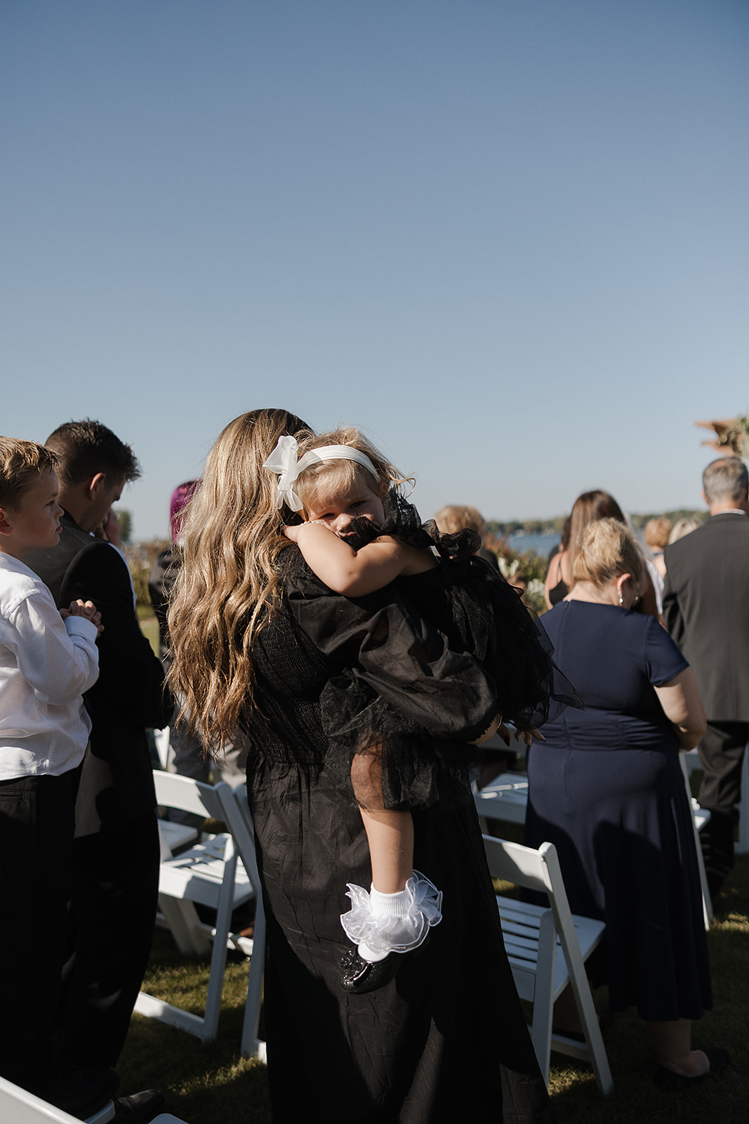 Wedding guest holding a baby at a wedding ceremony