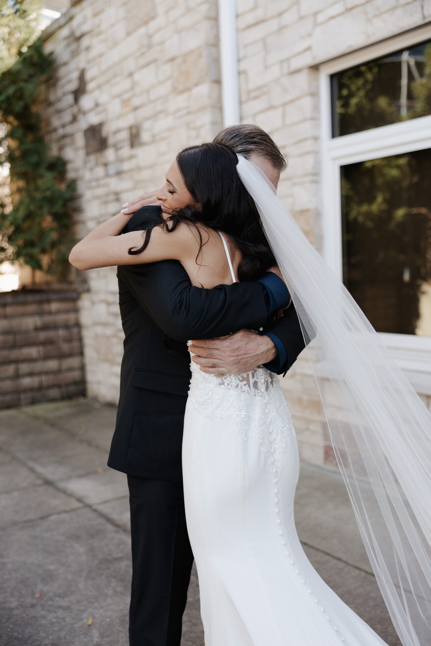 Bride and her father hugging during their wedding first look