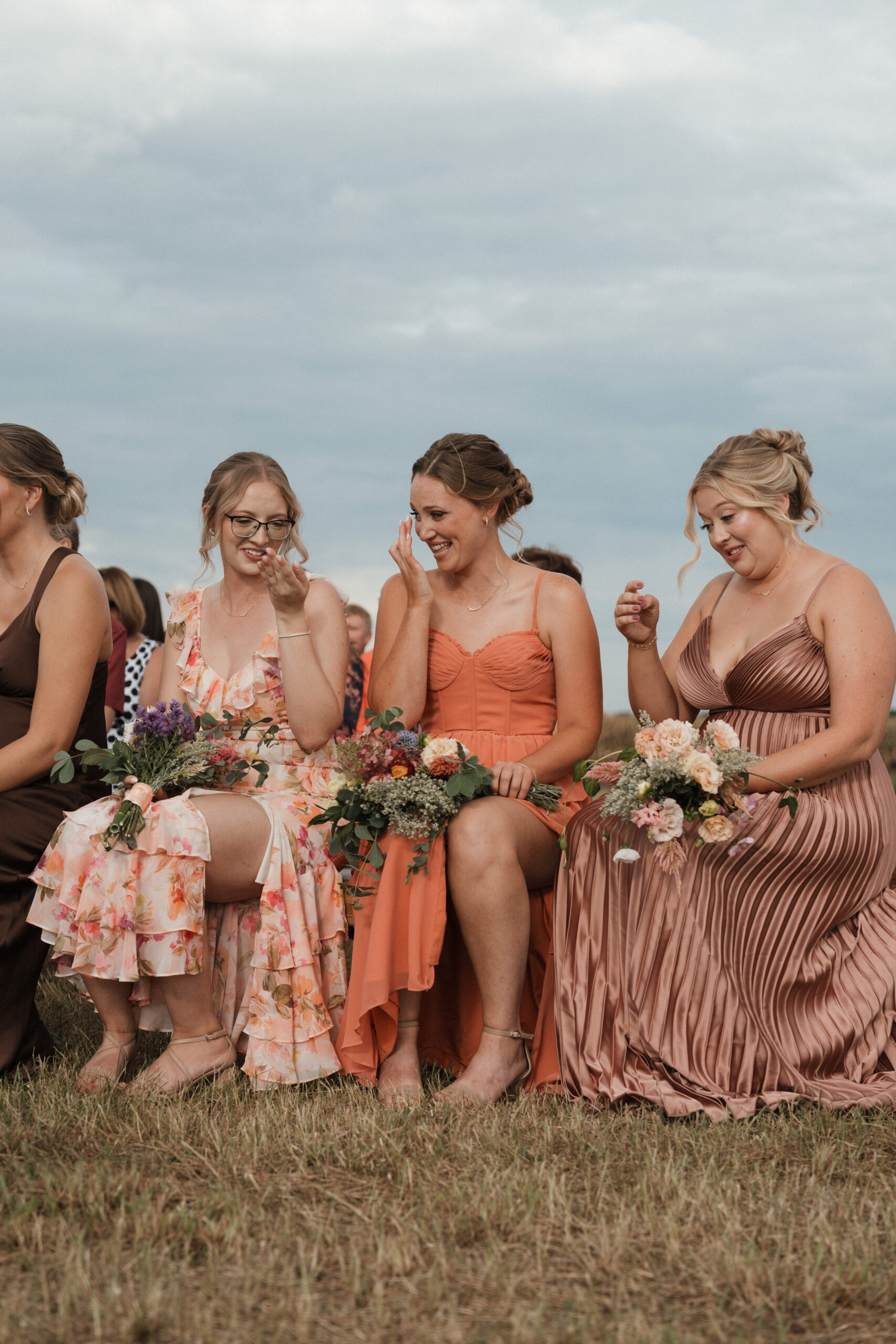 A candid wedding photo of bridesmaids crying during the ceremony