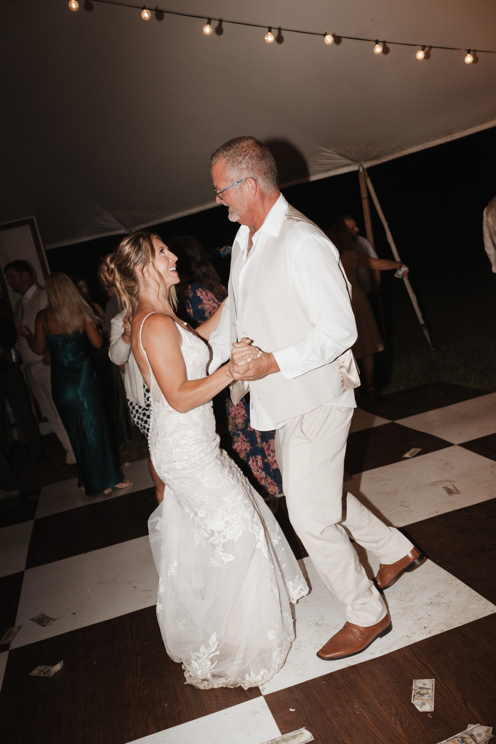 A bride and her father dancing together