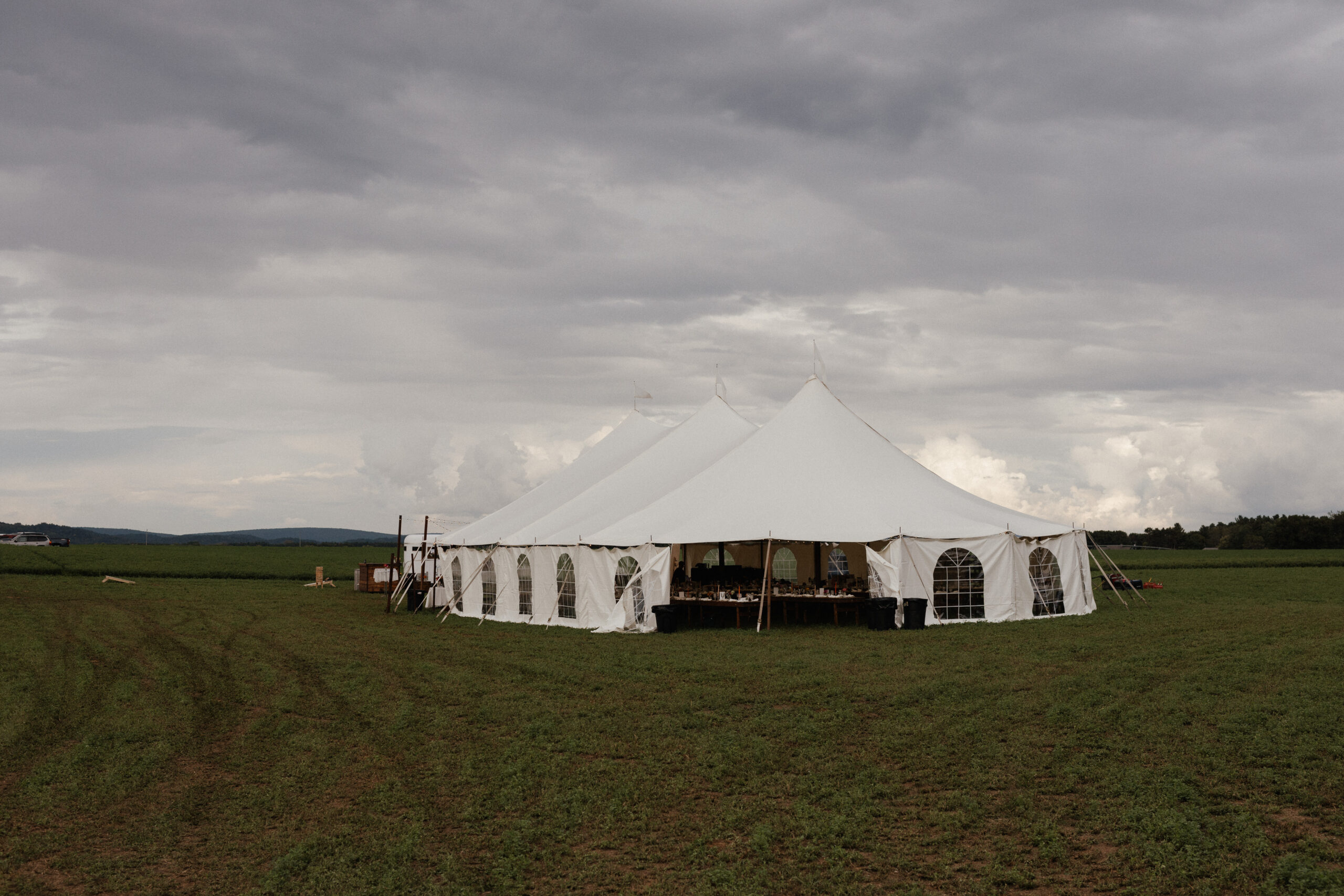 An outdoor tent set up for a backyard wedding
