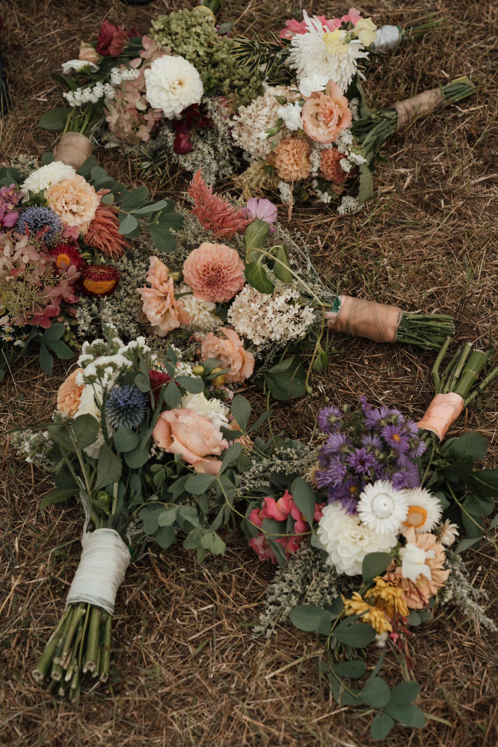 Bridesmaid's wedding bouquets laying on the ground