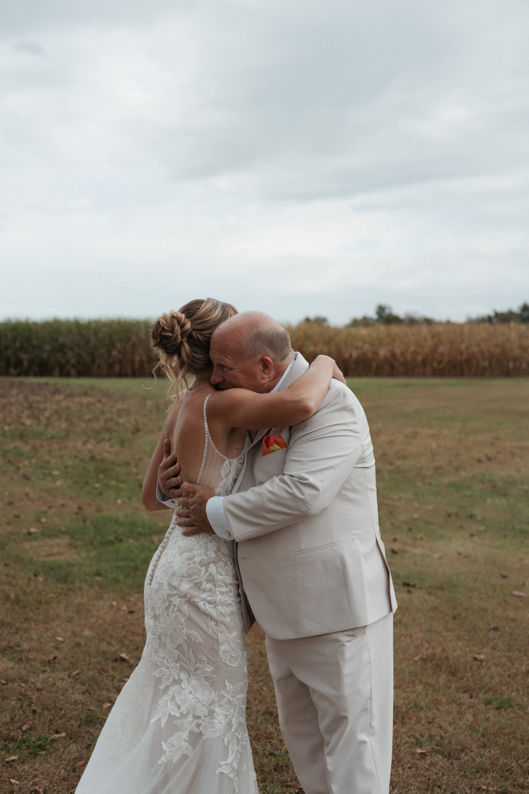 A bride hugging her father during wedding first look photos