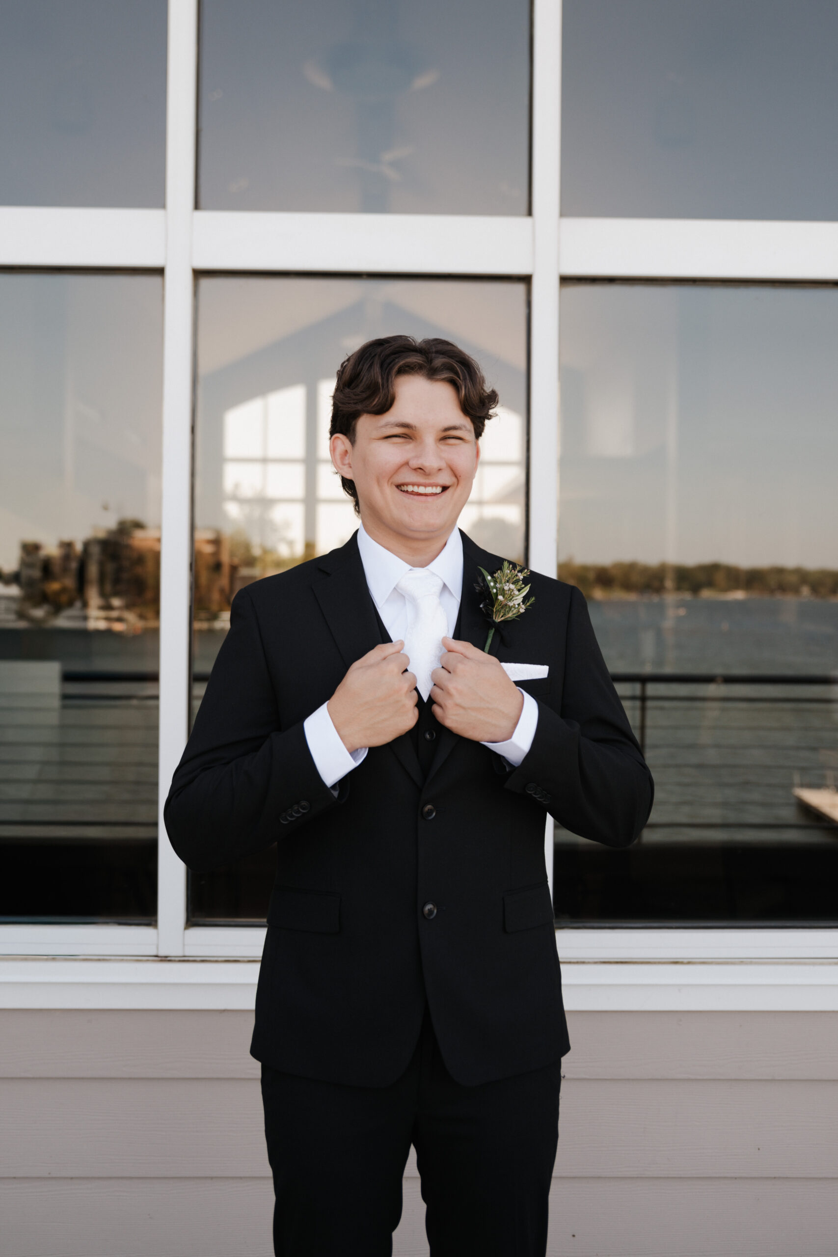 Groom smiling in his tux before the wedding ceremony