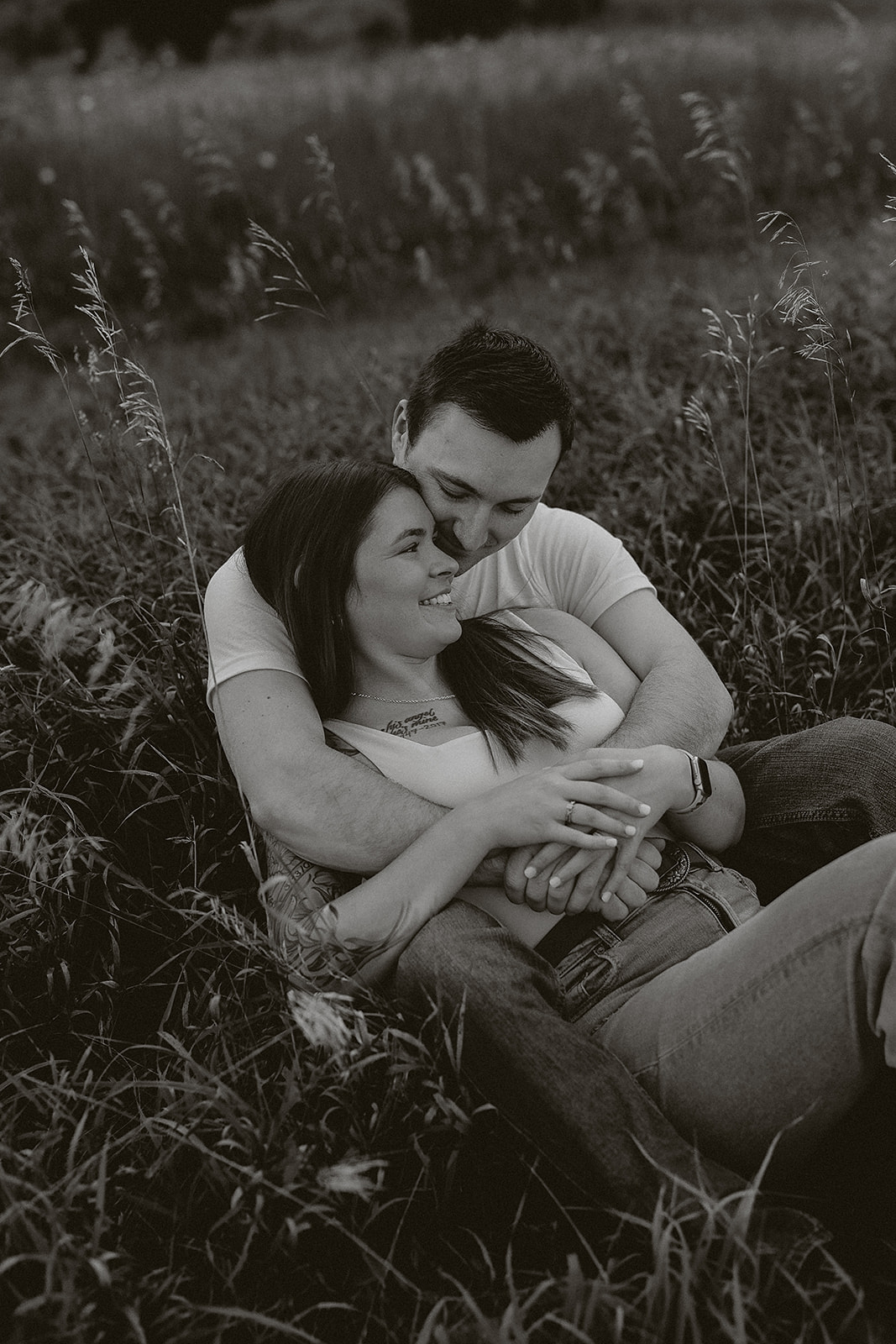 A couple laying in a field talking to each other