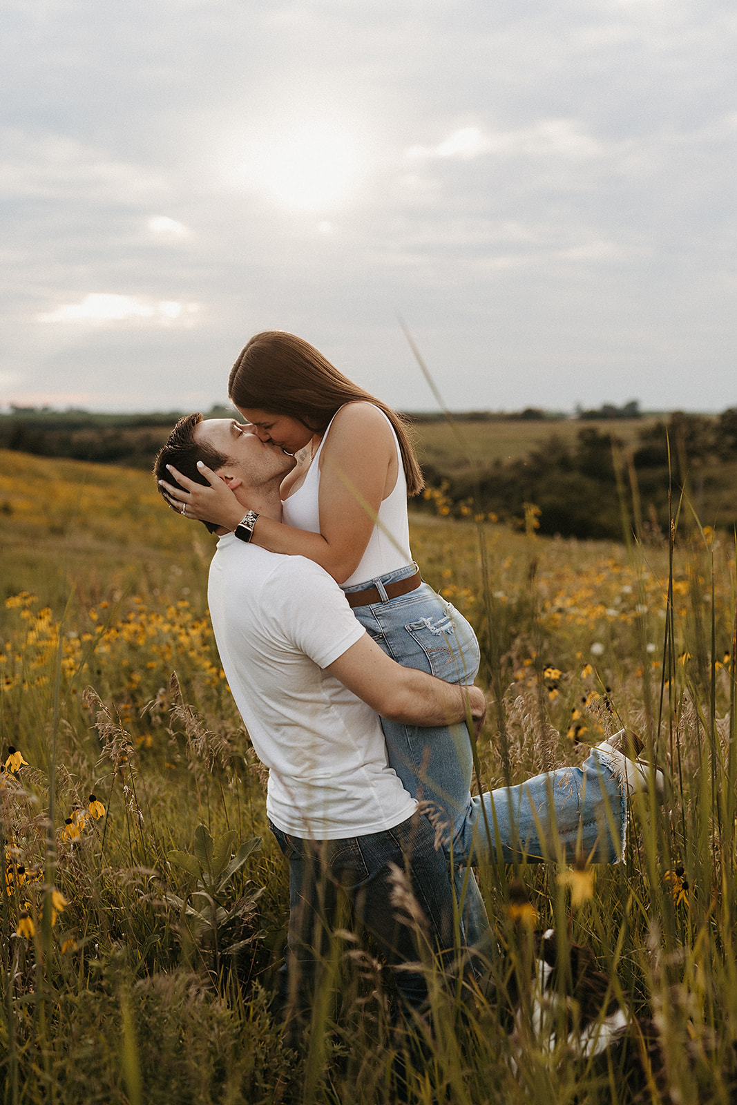 A man kissing his fiancee as engagement photo ideas
