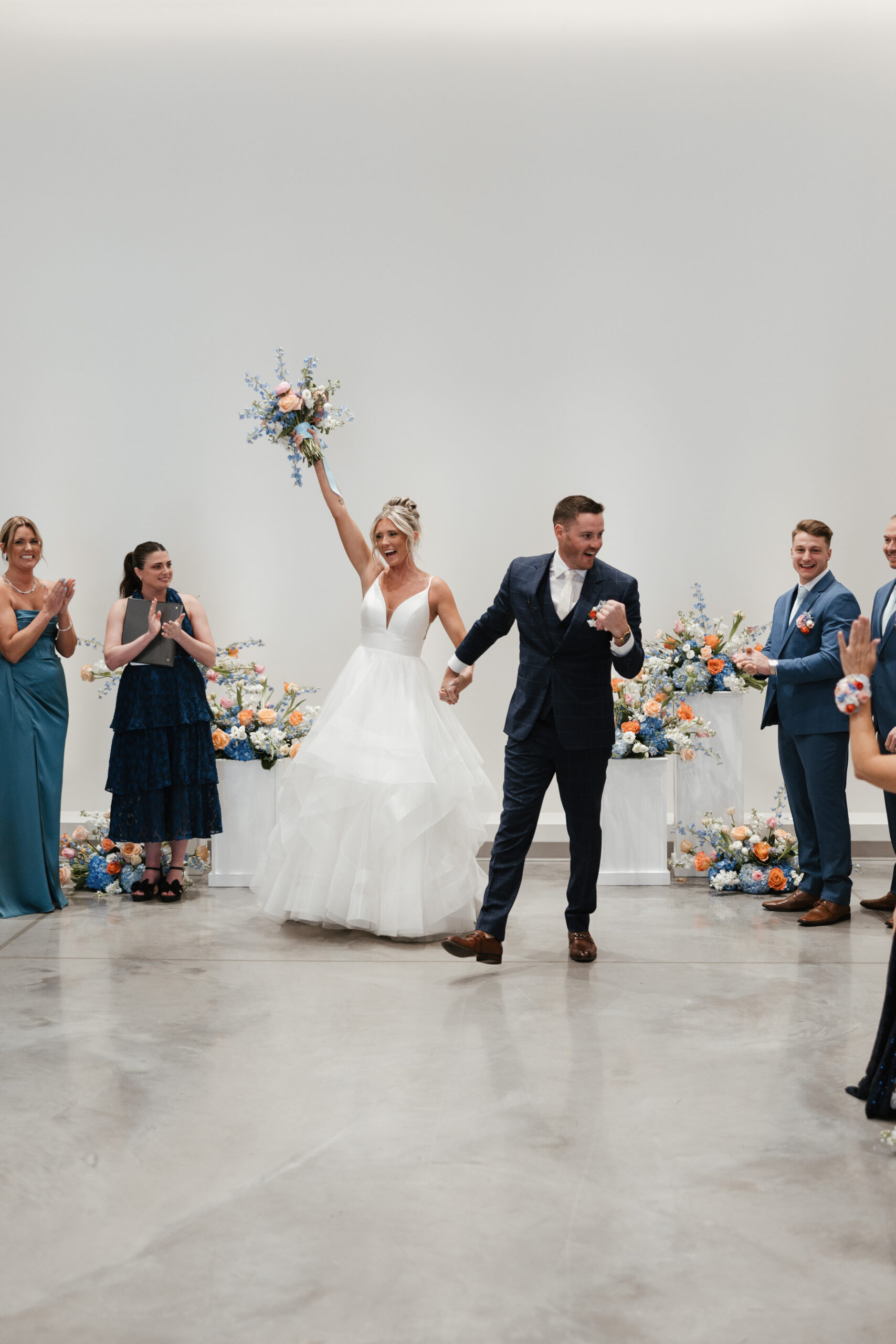 A couple cheering after their wedding ceremony