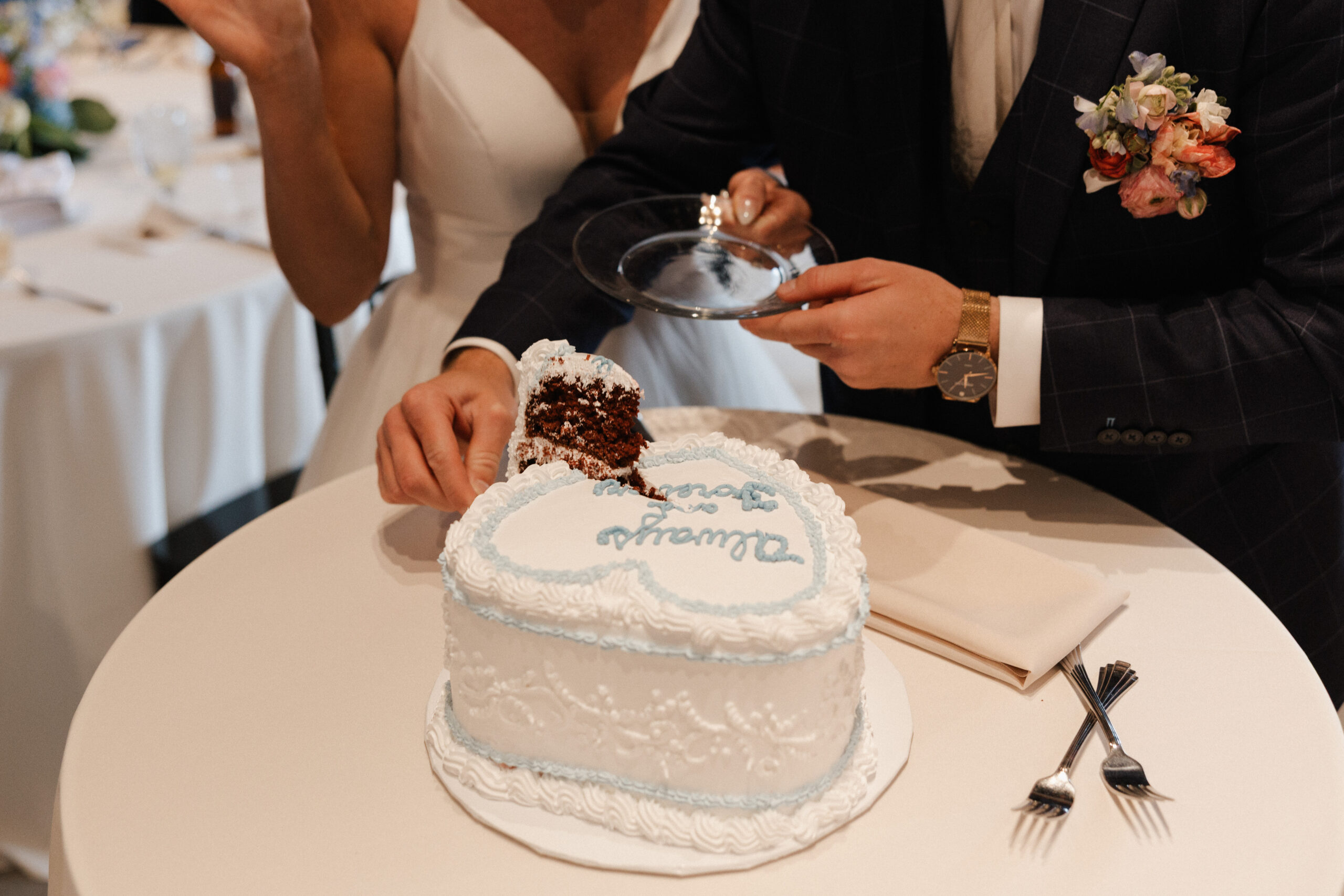 A bride and groom cutting their vintage wedding cake