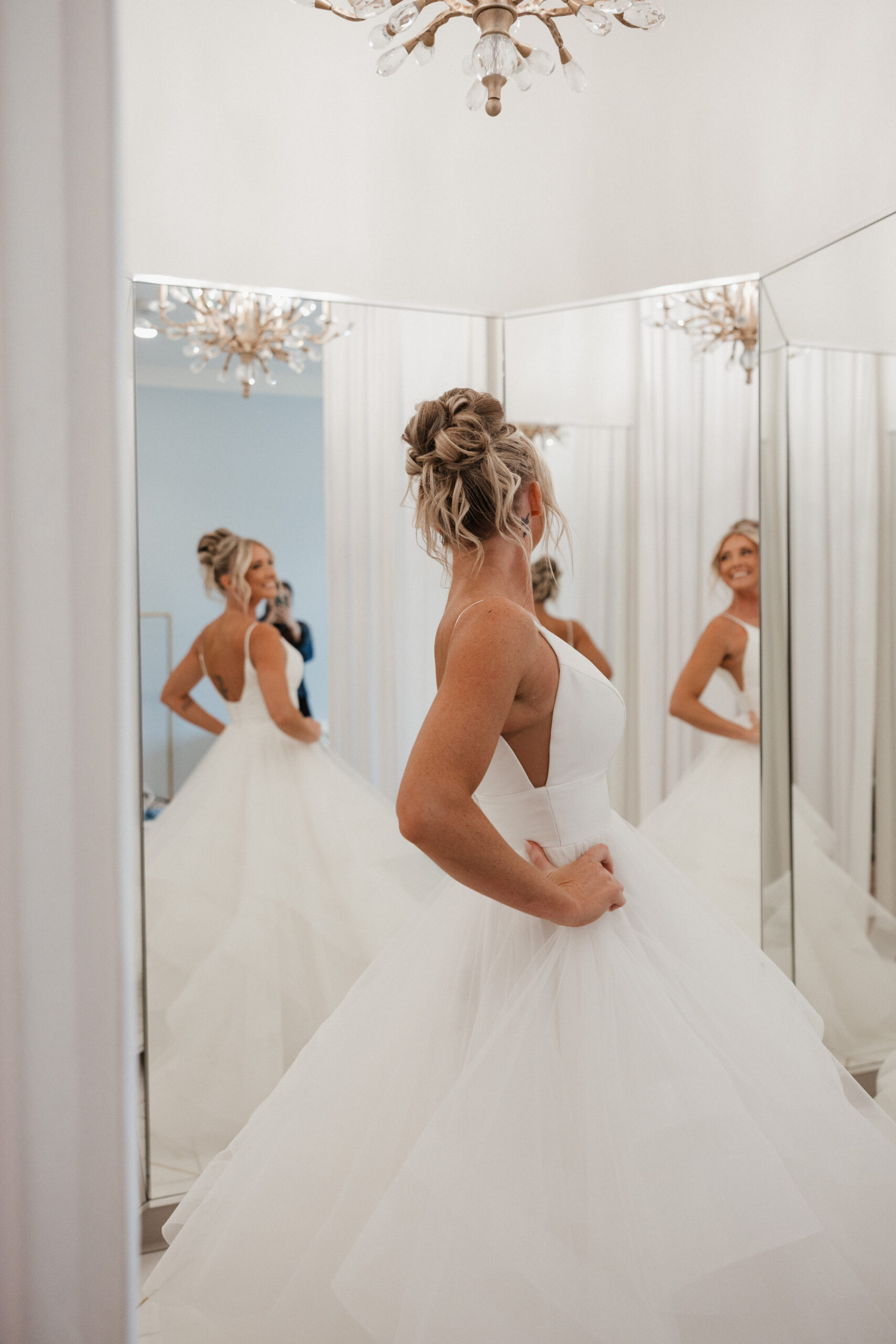A bride putting on her wedding dress while she's getting ready for her wedding at the Valerie