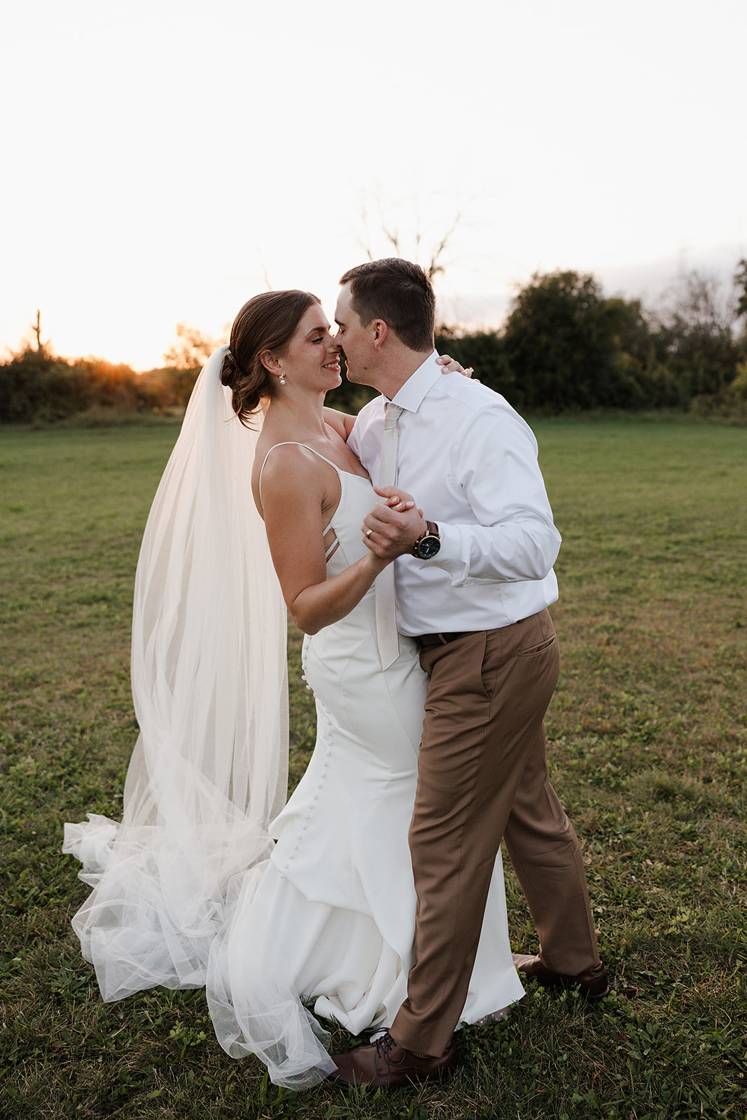 A bride and groom dancing at sunset during wedding photography