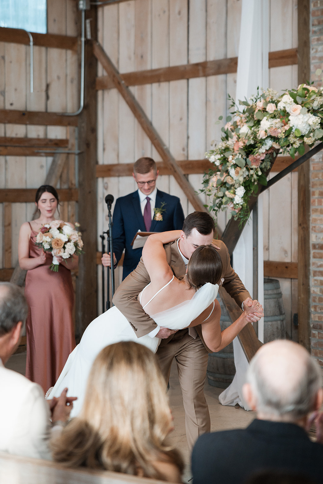 A bride and groom sharing their first kiss at their wedding ceremony