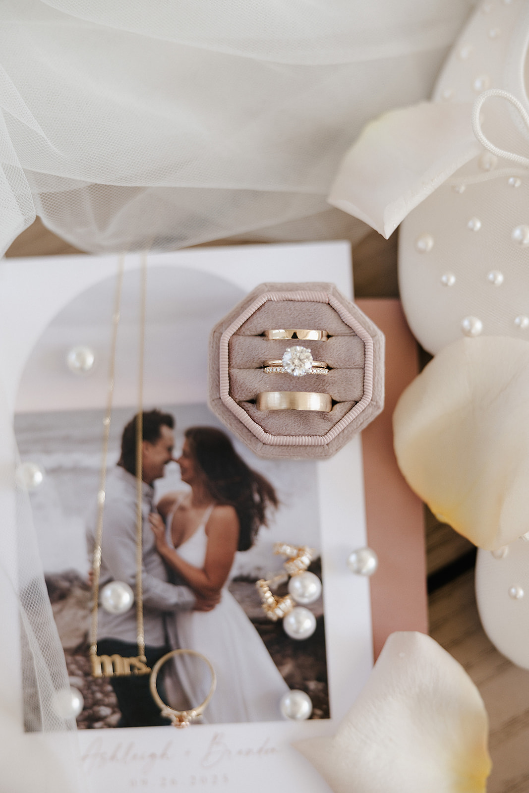 A wedding flatlay with wedding jewelry and invitations, taken by a Wisconsin wedding photographer