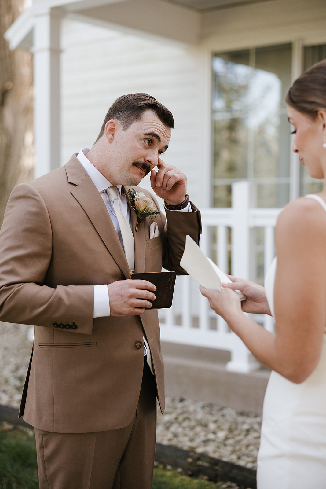 A groom crying during a wedding first look