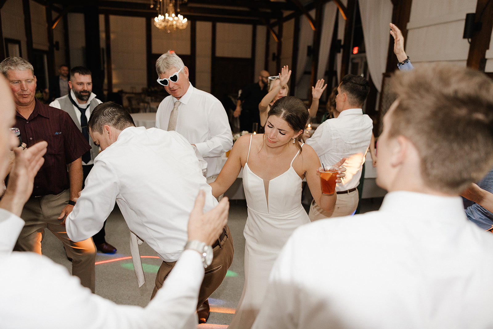 A candid wedding photo of a bride and groom dancing at their wedding reception