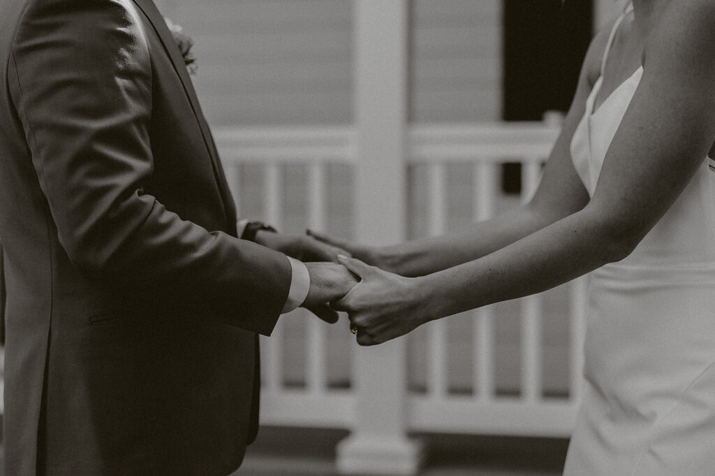A bride and groom holding hands, the final photo in a blog post answering the question "how much does a wedding photographer cost"