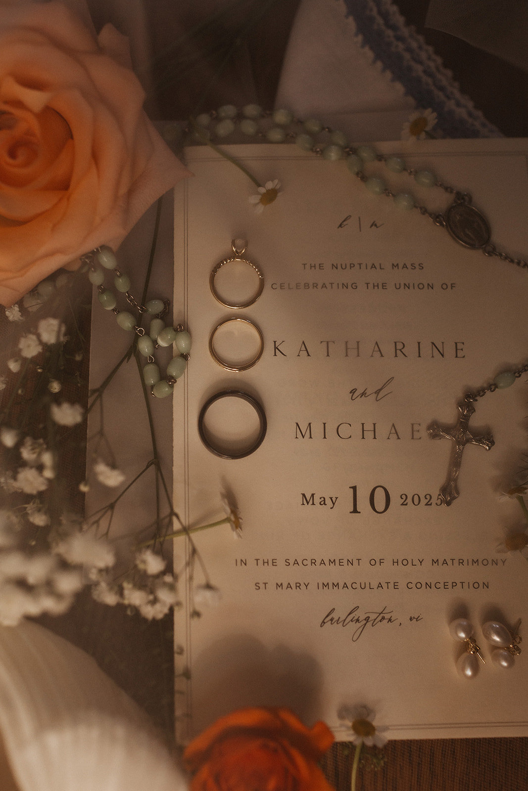 A wedding invitation and rings