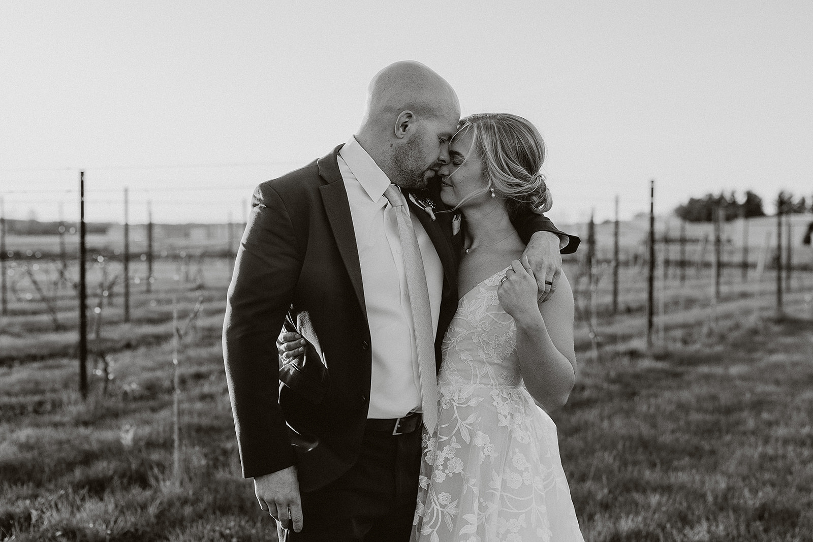 A bride and groom taking sunset photos at that spot in their wedding reception timeline