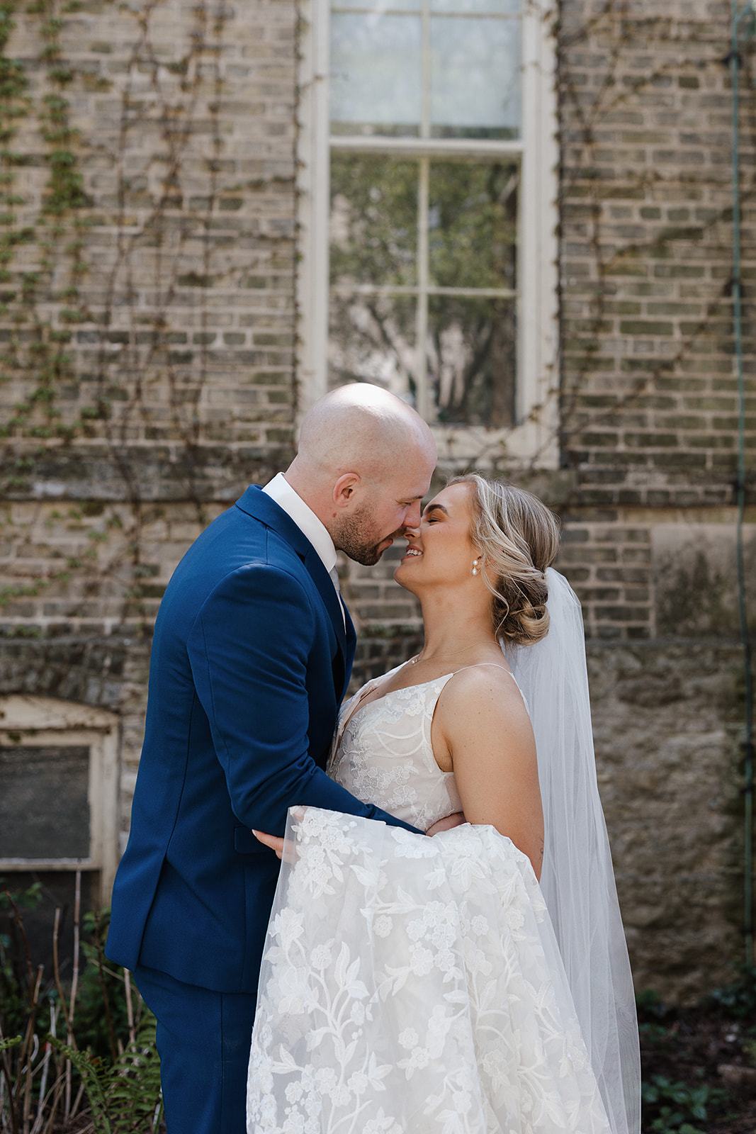A bride and groom kissing during the portrait section of their wedding reception timeline