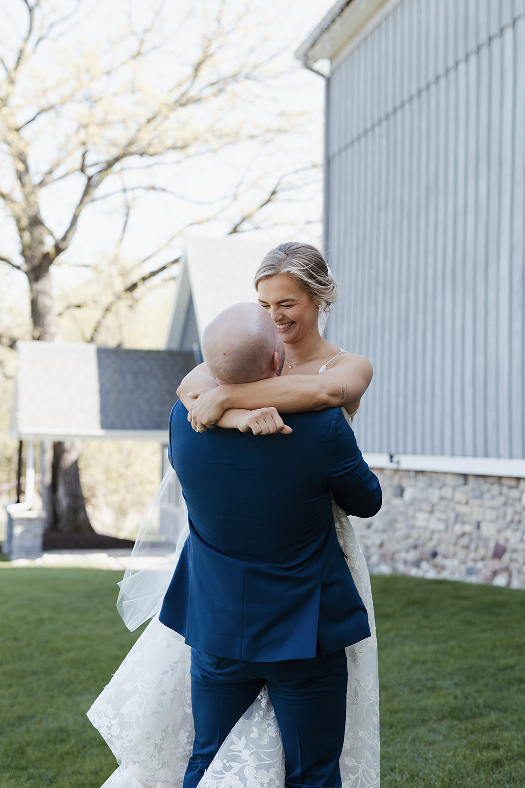 A groom lifting up a bride during wedding portraits