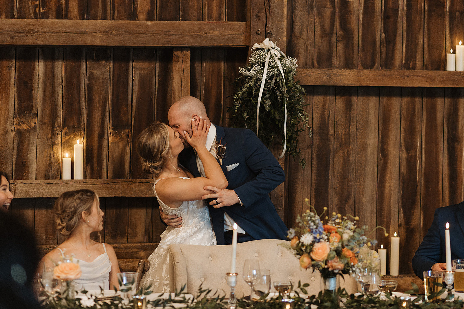 A bride and groom kissing during their wedding reception timeline