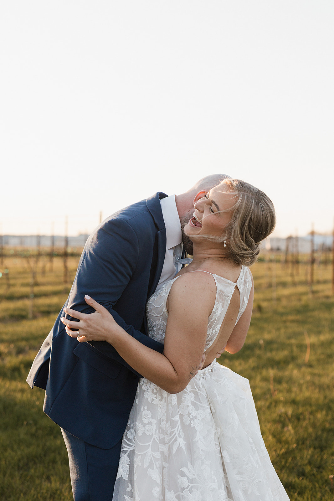 A bride and groom posing for sunset wedding photos