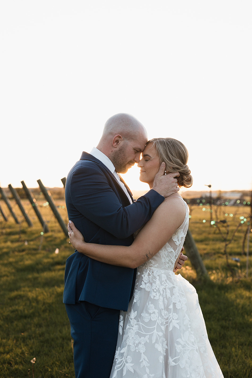 A bride and groom taking the sunset photos from their wedding reception timeline