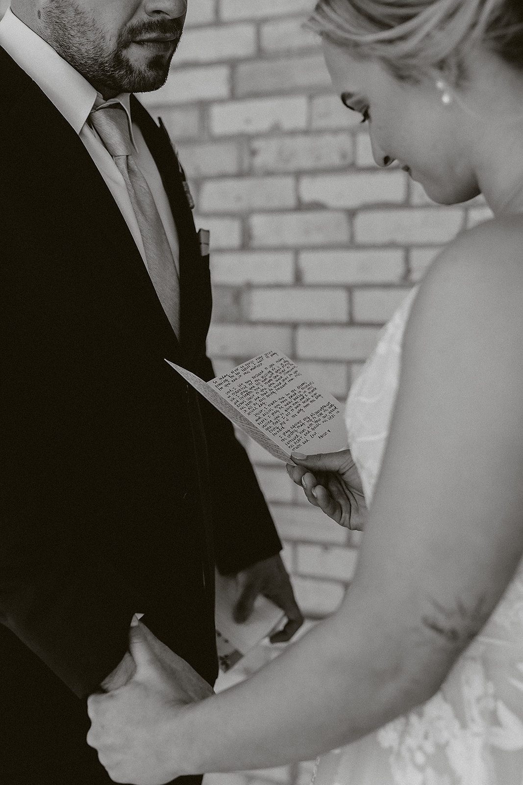 A bride and groom reading private vows