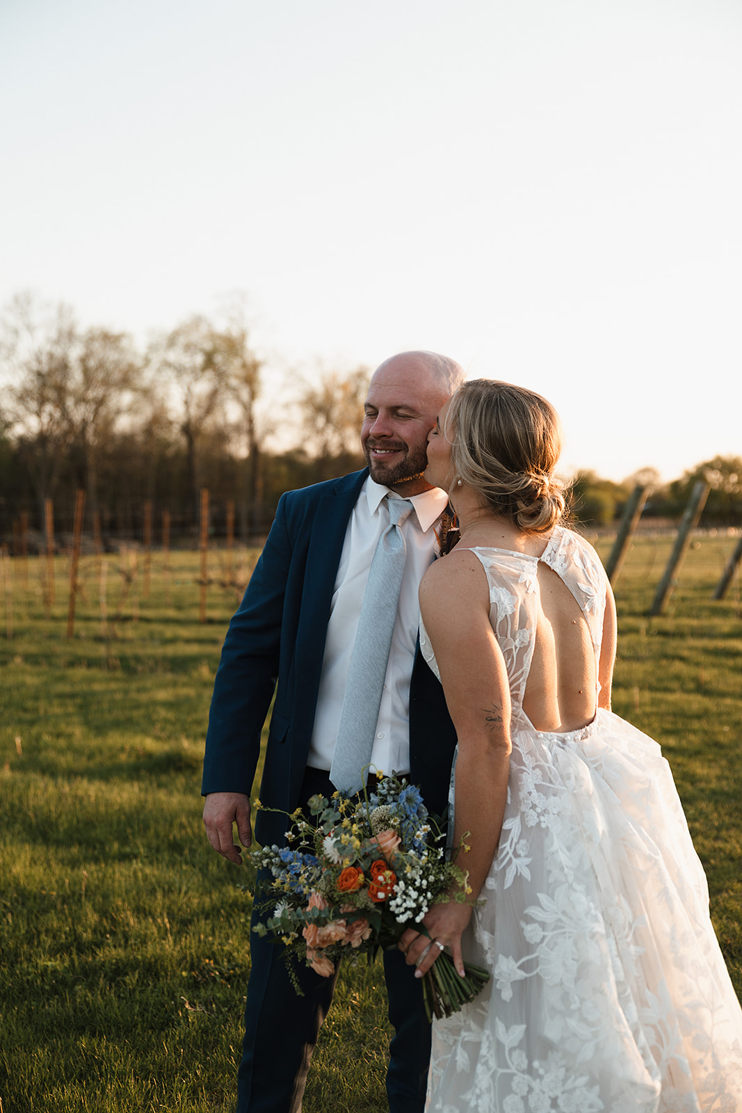 A bride and groom taking the sunset photos from their wedding reception timeline
