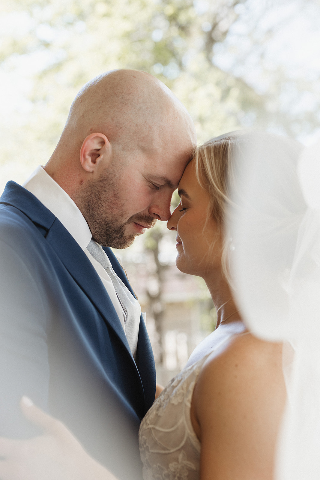 A bride and groom taking wedding portraits