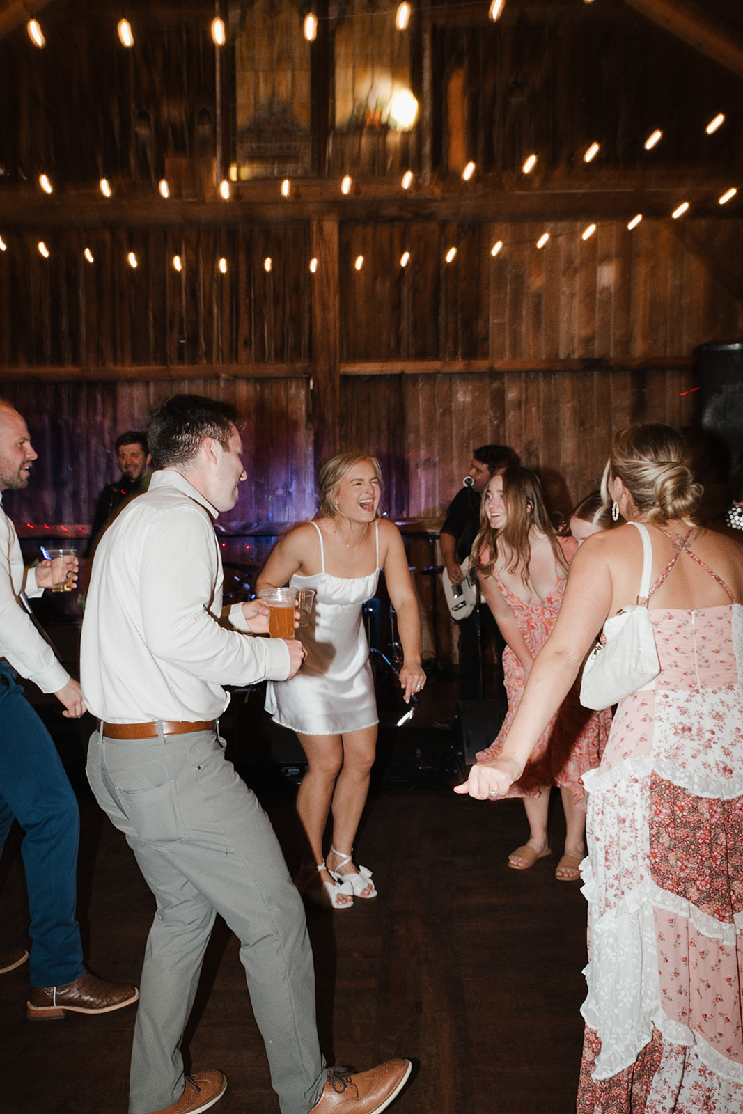 A candid wedding reception photo of a bride dancing