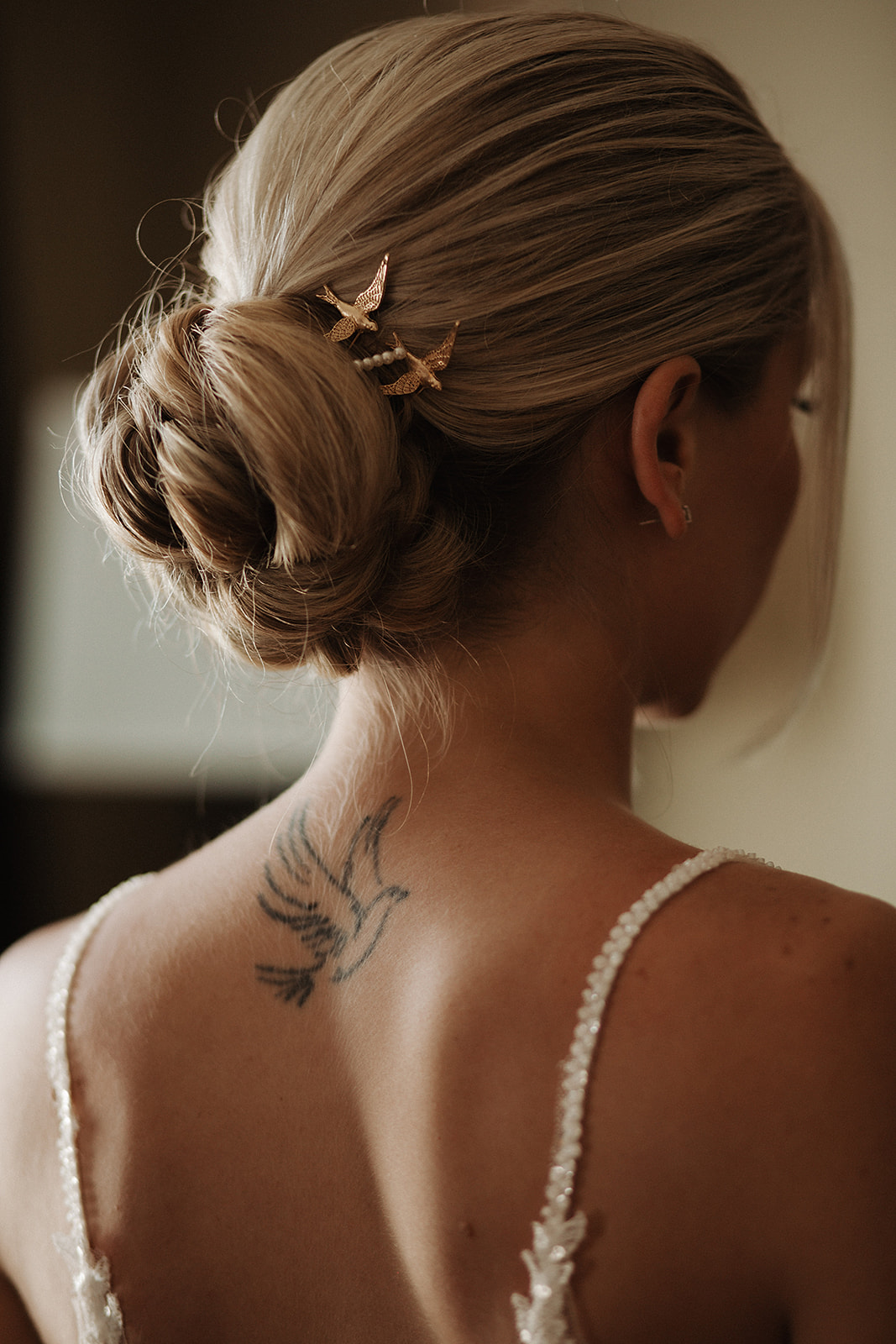 A bride's wedding hair with bird pins