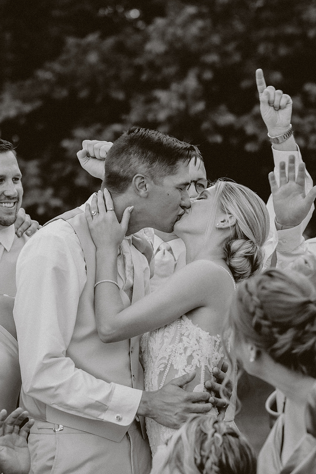 A bride and groom posing for black and white wedding photos