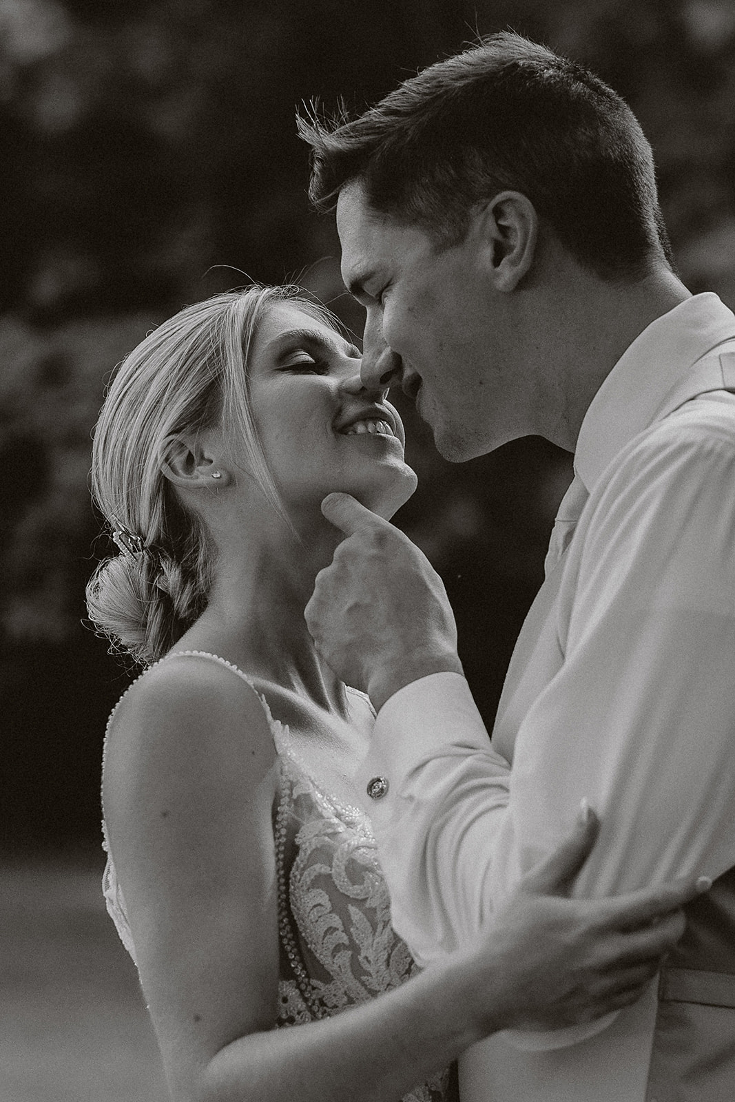 A bride and groom posing for black and white wedding photos