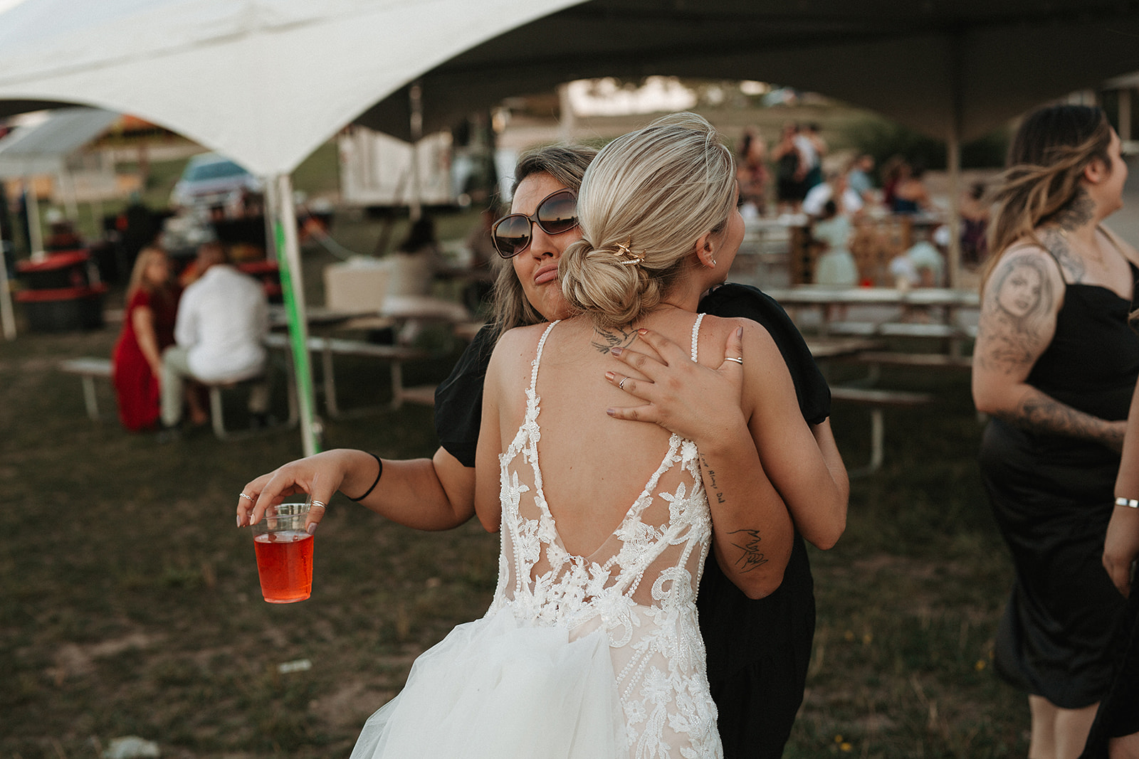 A bride hugging a wedding guest, taken by a Milwaukee wedding photographer