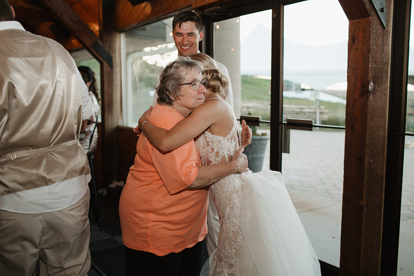 A bride hugging a wedding guest, taken by a Milwaukee wedding photographer