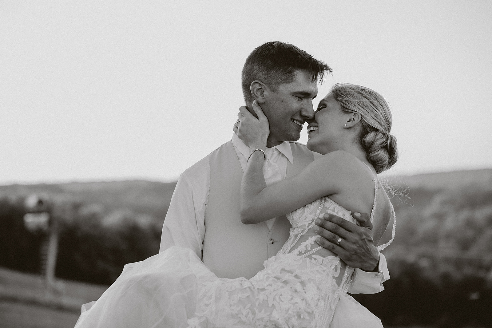 A bride and groom kissing in a black and white photo taken by a Milwaukee wedding photographer