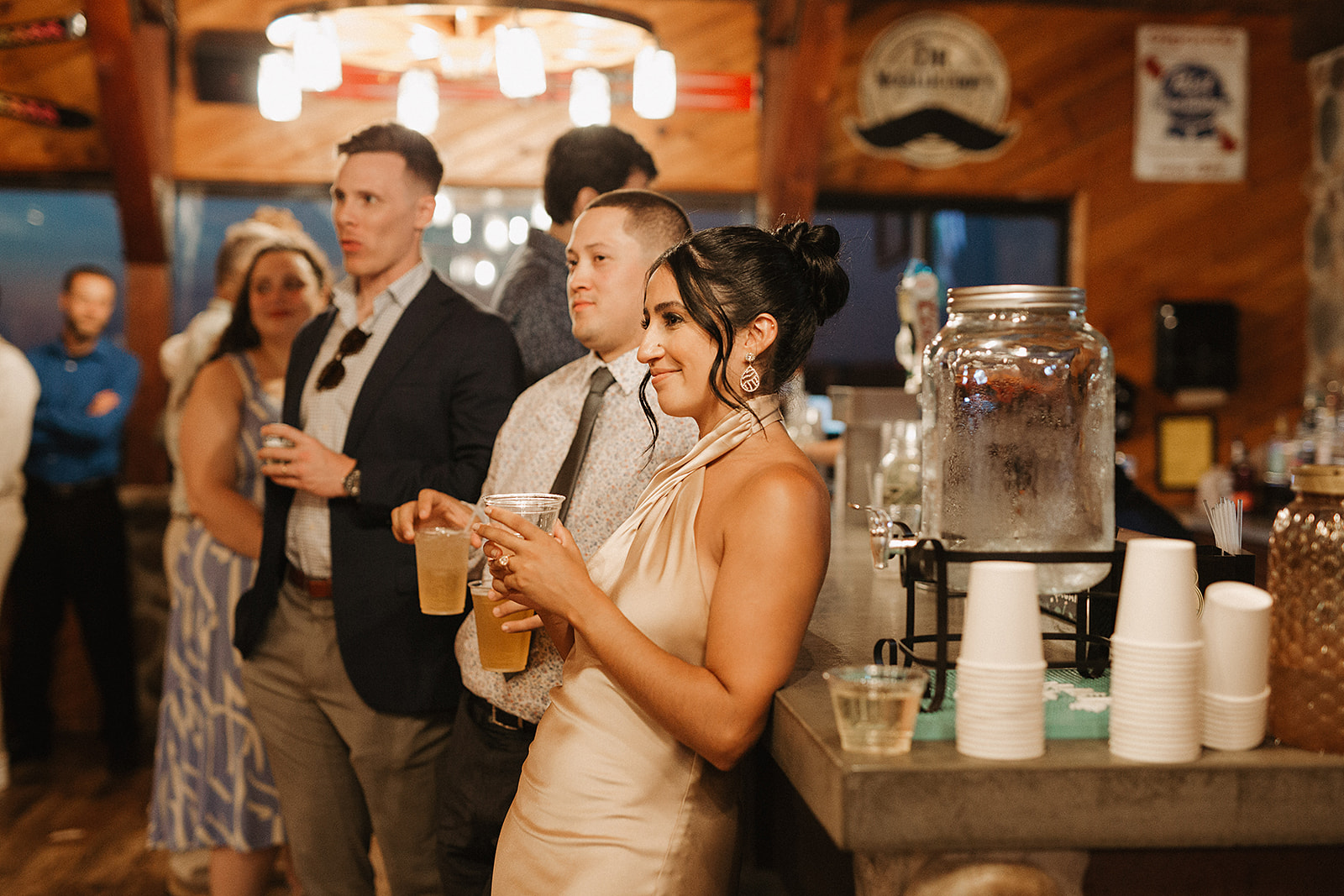 A candid wedding photo of guests watching a bride and groom dance, taken by a Milwaukee wedding photographer