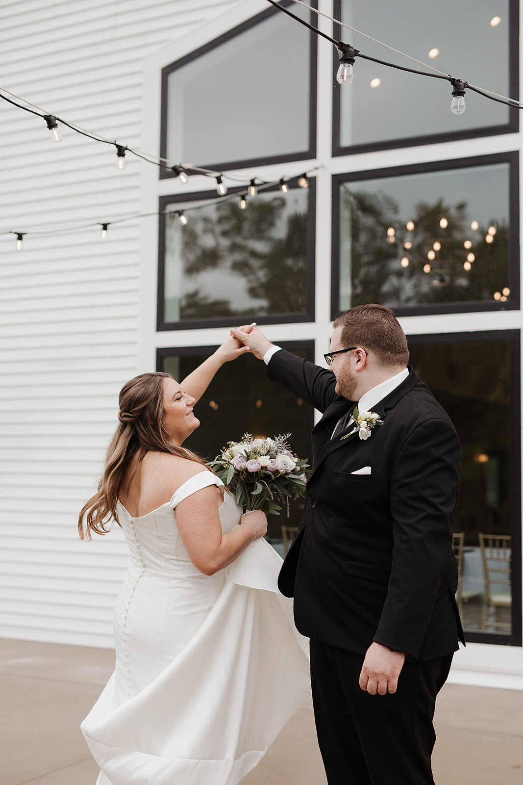 A bride and groom dancing in front of their luxury wedding venue, the eloise