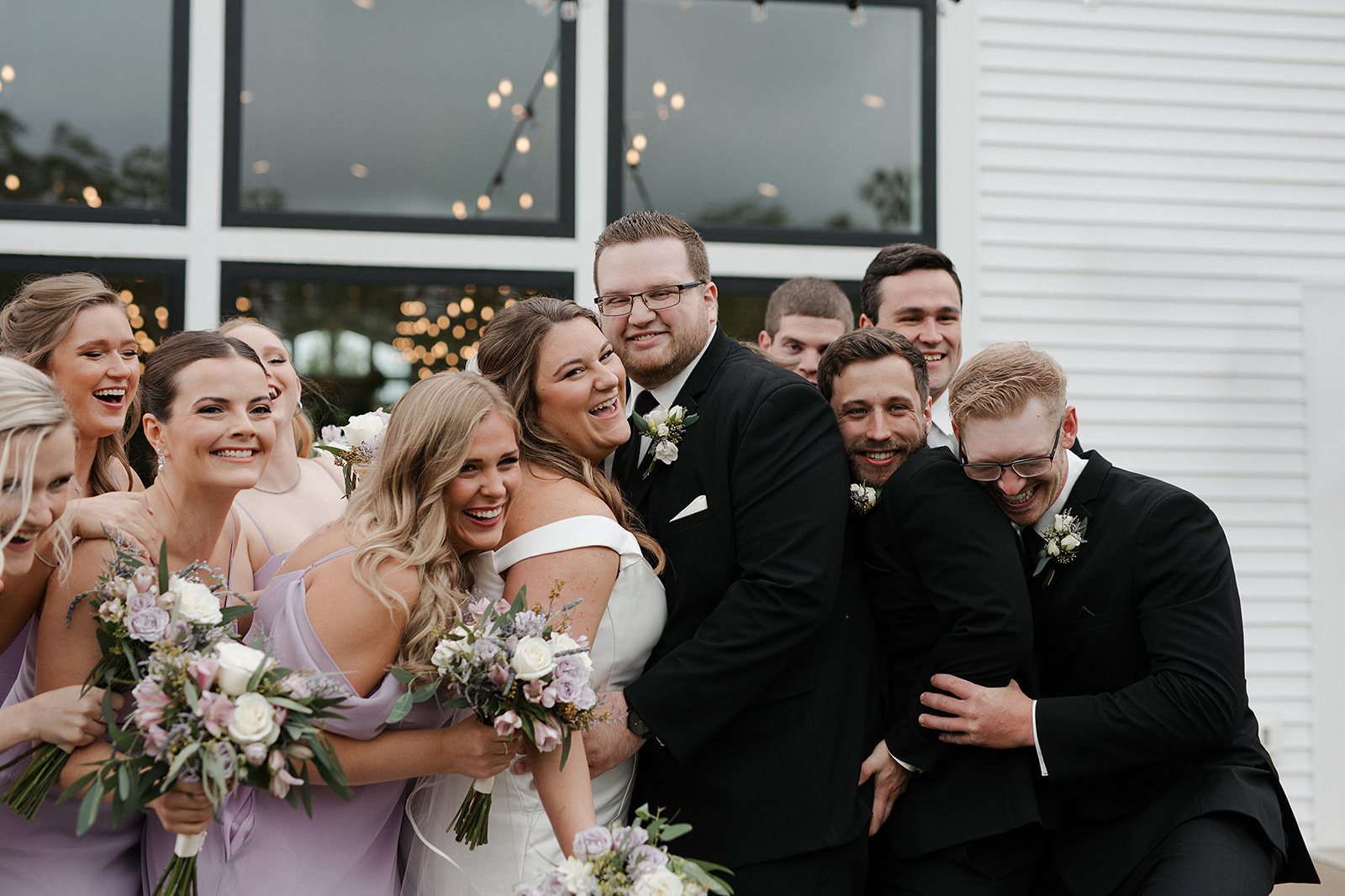 A wedding party posing for photos in front of the eloise