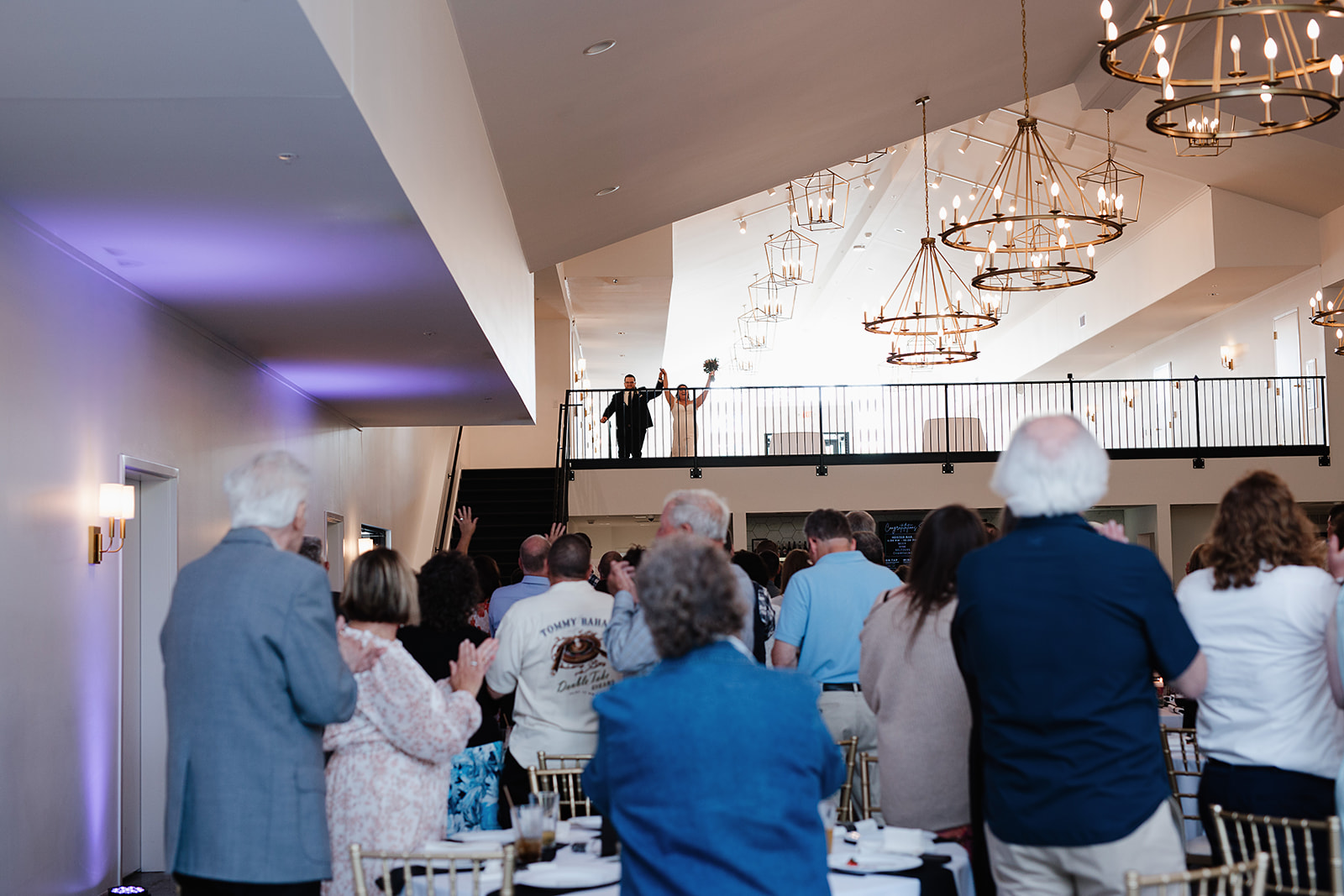 A bride and groom entering a wedding reception at the eloise