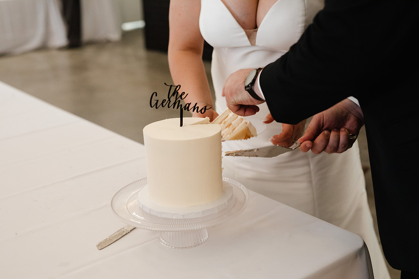 A bride and groom cutting their cake