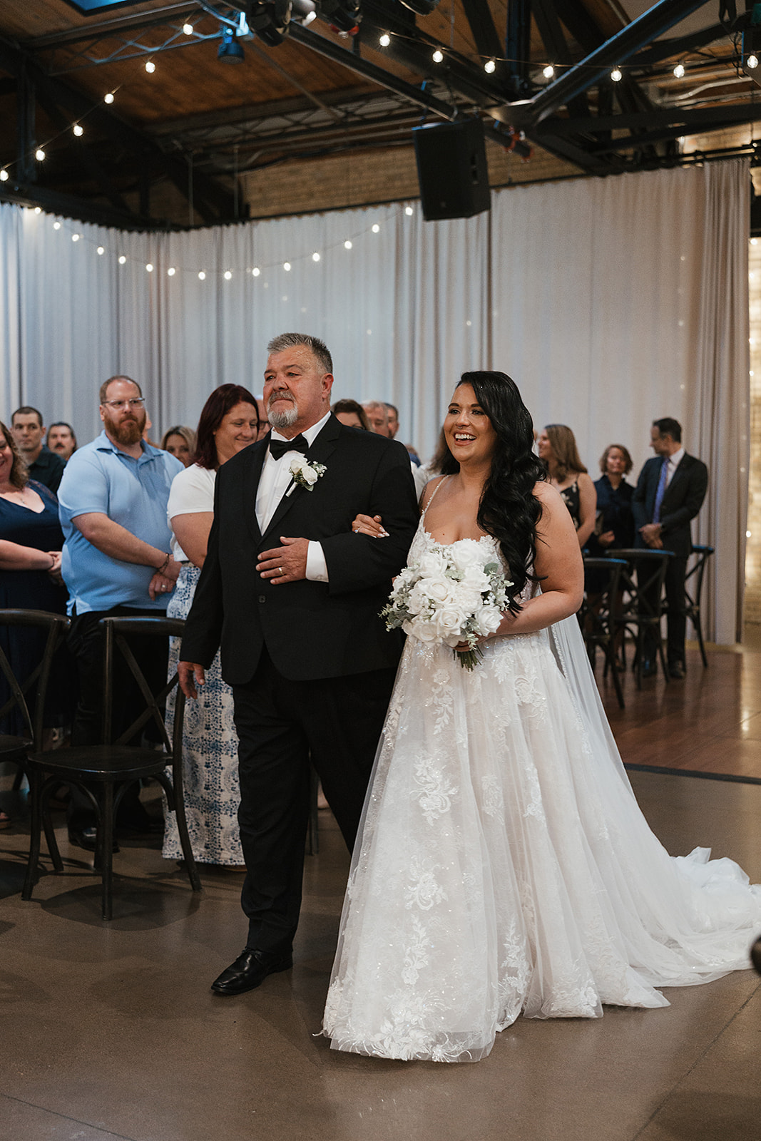 Bride and father walk down aisle at the Wisconsin wedding venue