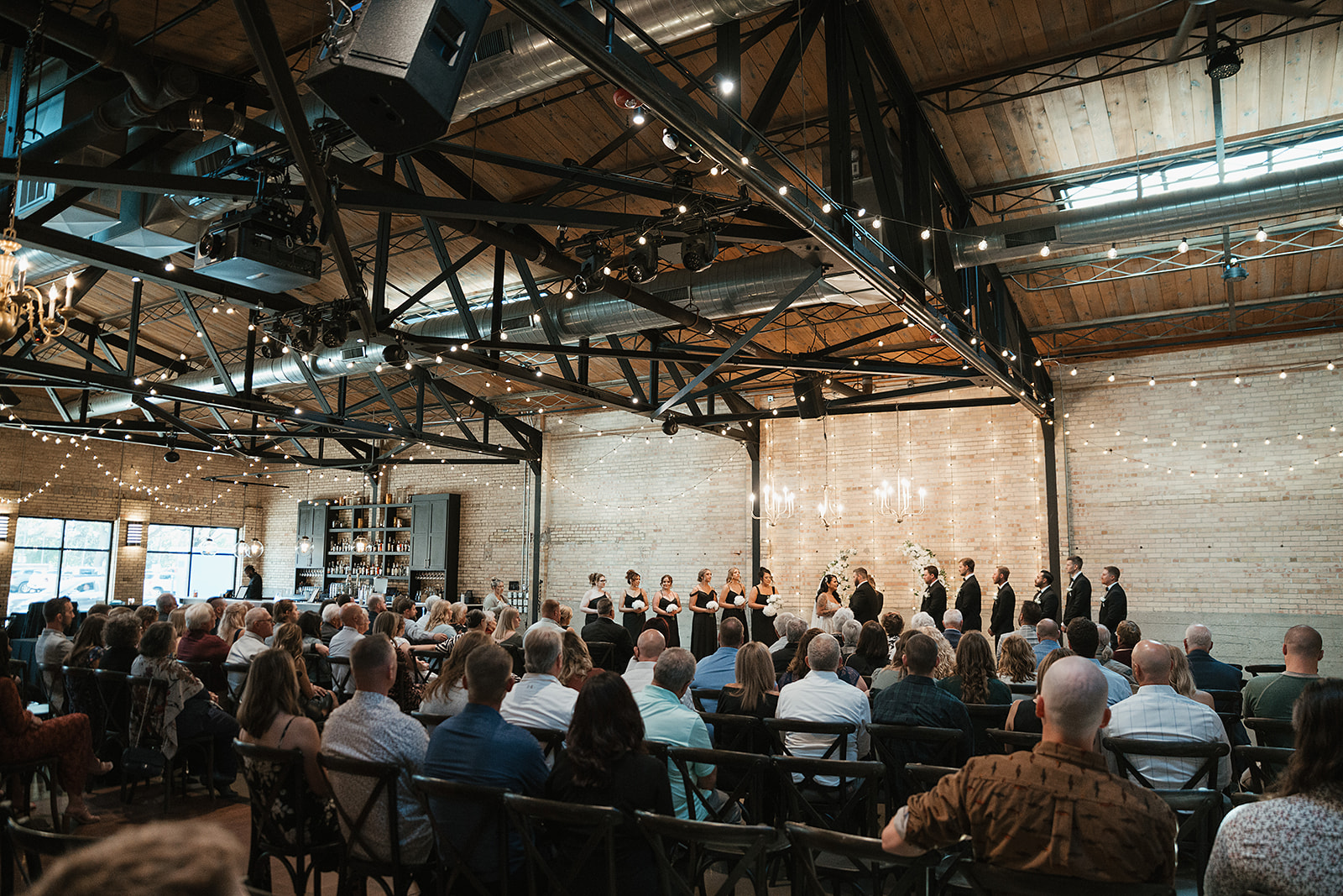 Guests watch the wedding ceremony at the Green Bay wedding venue