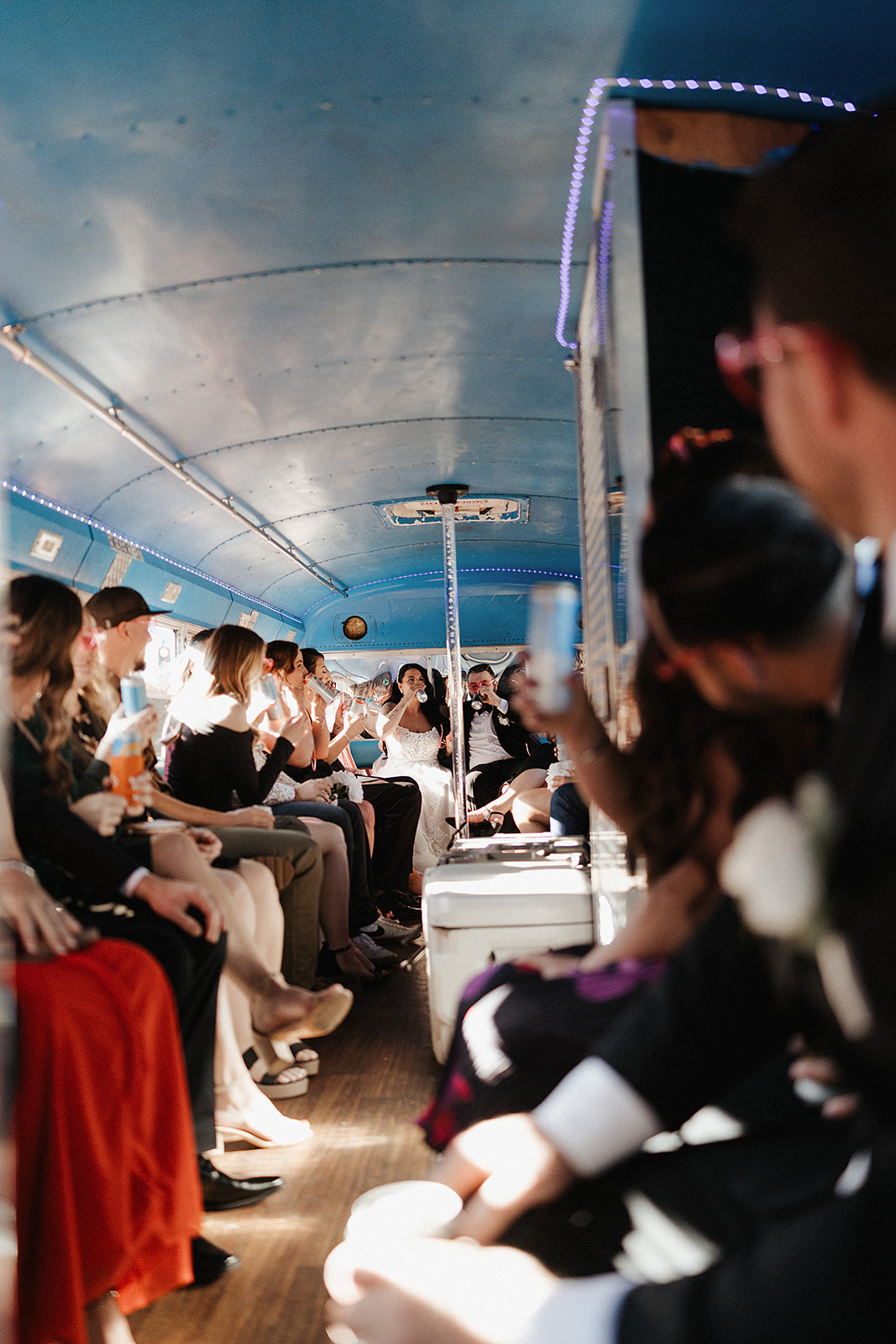 Guests dancing and celebrating inside lively reception bus