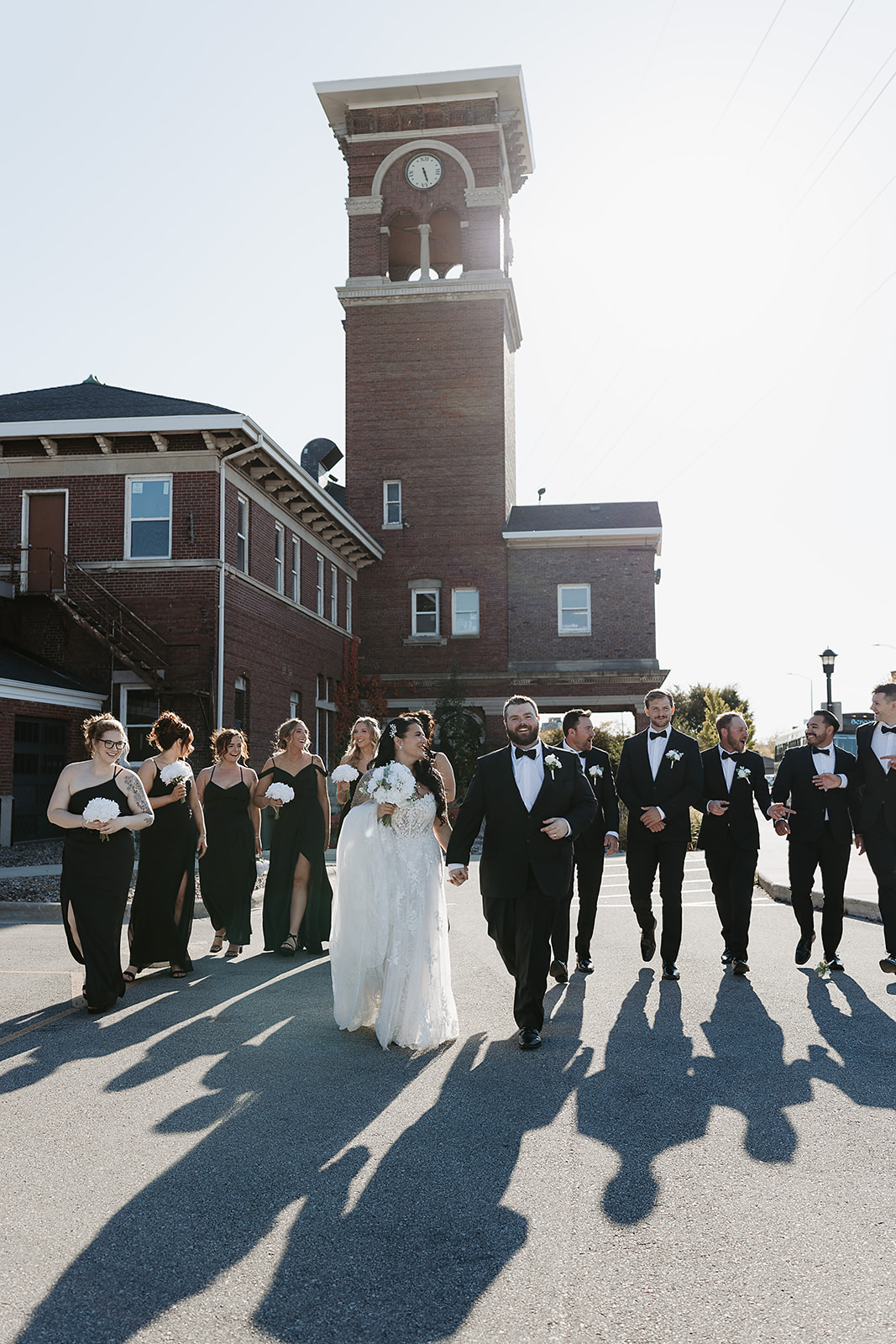 Green Bay wedding venue couple walking with wedding party downtown