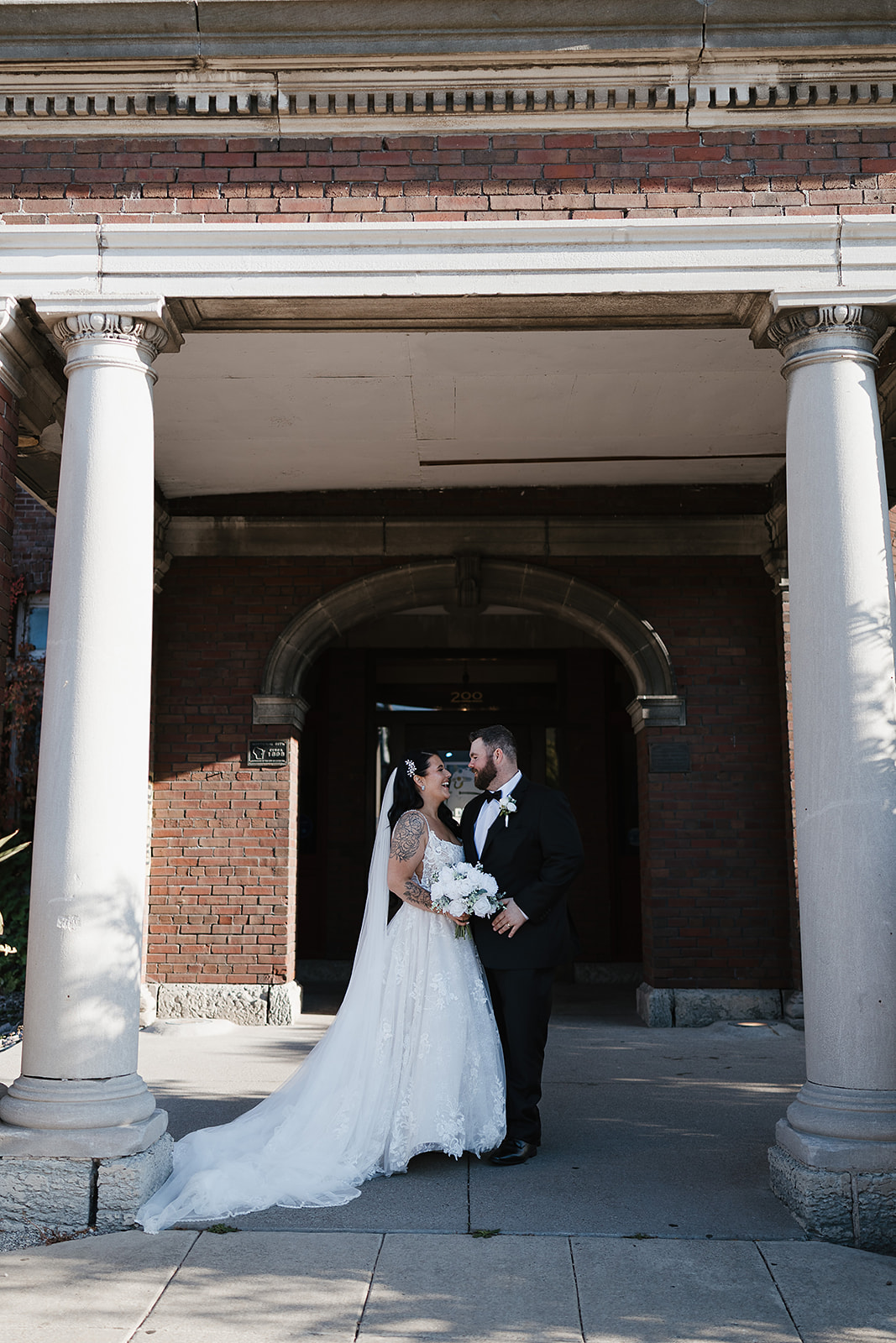 couple standing under covered entrance at their Green Bay wedding venue