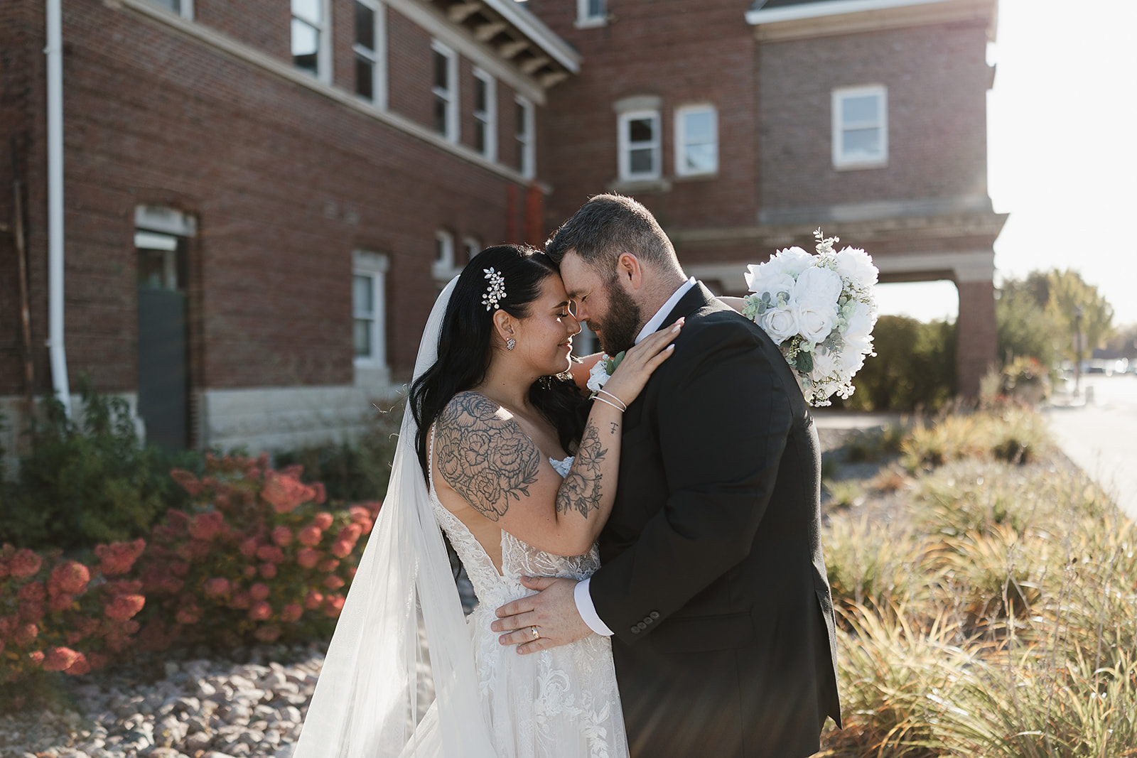 Green Bay wedding venue couple kissing outdoors in sunlight