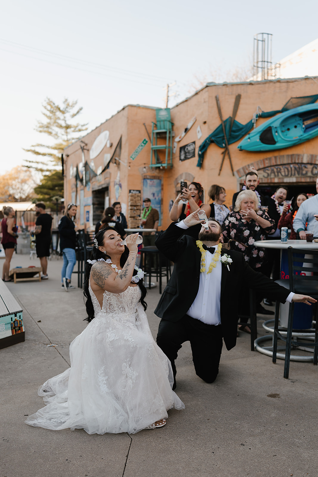 Green Bay wedding venue couple chugging drink with cheering crowd